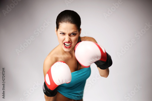 Photo: Young beautiful women wiht boxing gloves. Young beautiful women wiht boxing gloves.
