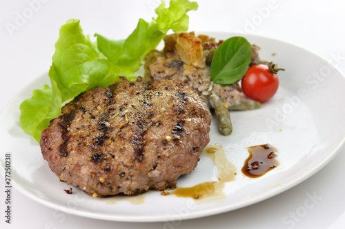 Photo: grilled hamburger with salad leaves grilled hamburger with salad leaves