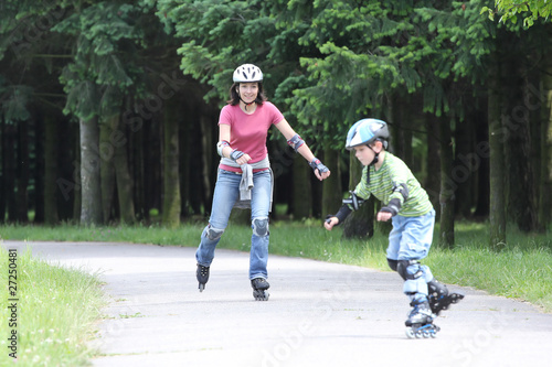 Photo: Happy family learning to ride on rollerblades Happy family learning to ride on rollerblades