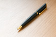 Writing silver pen on the wooden background