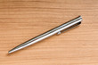 Writing silver pen on the wooden background