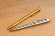 Writing silver pen on the wooden background