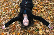 Photo: Woman laying in autumn leaves Woman laying in autumn leaves
