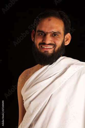 Photo: muslim pilgrim in white traditional clothes muslim pilgrim in white traditional clothes