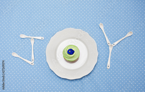 Photo: teaspoons and plate with cupcake spelling "joy" on tablecloth teaspoons and plate with cupcake spelling "joy" on tablecloth