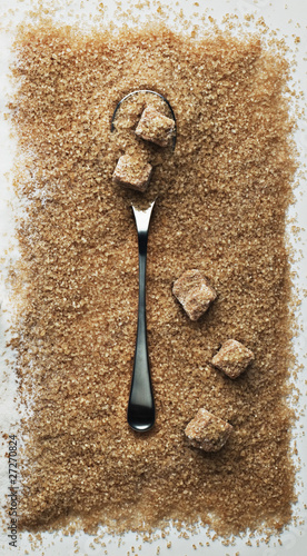 Photo: spoon in heap of turbinado sugar spoon in heap of turbinado sugar