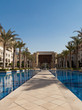 Photo: Fairy arabian palace. Palms alley between two ponds. Fairy arabian palace. Palms alley between two ponds.