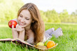 Girl with book and apples