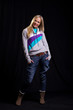 Informal blonde in casual clothing posing on the black backdrop