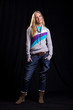 nformal blonde in casual clothing posing on the black backdrop