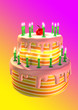 A big colored birthday cake with green candles