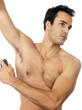Foto: Young Man Applying Deodorant. Model Released Young Man Applying Deodorant. Model Released