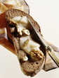 Slice of bread spread with creamy honey and walnuts