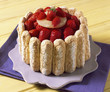 Decorating the flower-shaped charlotte with strawberries