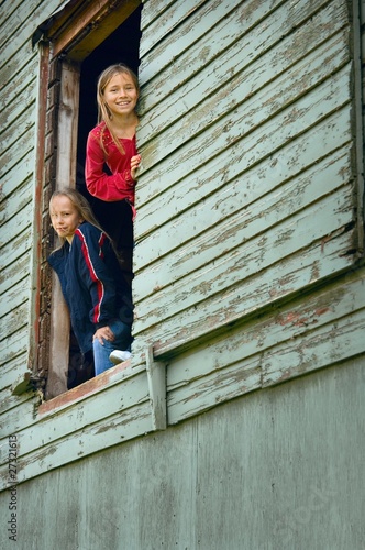 Photo: Girls Looking Out Of A Barn Girls Looking Out Of A Barn