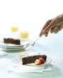 sprinkling chocolate cake with icing sugar