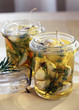 Garlic marinating in oil with rosemary and thyme