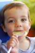 Young boy licking a lollipop