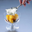 Adding the meringue in the glass bowl