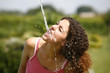 Woman drinking water from a spring
