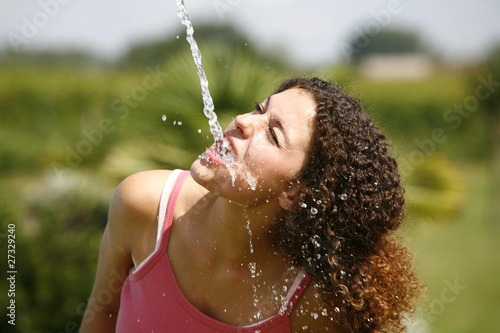 Photo: Woman drinking water from a spring Woman drinking water from a spring