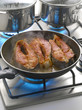 Cooking salmon steaks in a frying pan