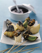 Fresh fruit Fondue with melted milk chocolate and crushed dried fruit and nuts