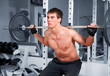 Muscular man working  with the rod