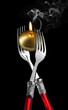 Two forks with golden candle ;candle light diner