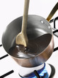 Mixing the melted chocolate with a wooden spoon