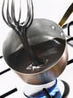 Whipping the melted chocolate in the copper saucepan