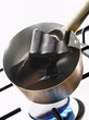 Melting dark chocolate in a copper saucepan