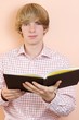Young handsome man holding an open book