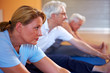 Frau dehnt sich im Fitnesscenter