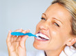 Closeup of a cheerful mature woman brushing her teeth Closeup of a cheerful mature woman brushing her teeth
