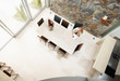 Woman sitting in a modern dining room - top view