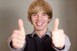 Young casaul man showing his both thumbs up