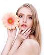 Young beautiful woman face with flower
