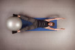 Overhead view of man exercising with large ball