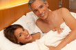 Photo: Happy Couple in Bed Happy Couple in Bed