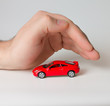 little red sports car under the man's hand little red sports car under the man's hand