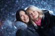 Girls enjoying winter on Christmas night snow background