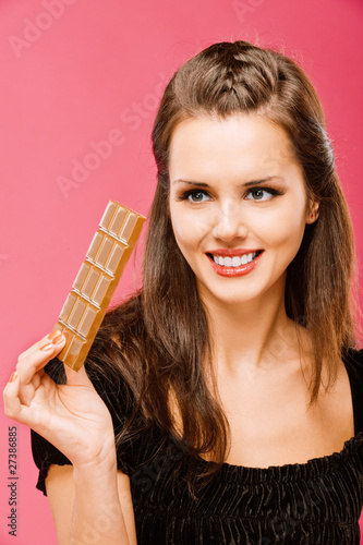 Photo: Dark-haired girl hold in hand chocolate Dark-haired girl hold in hand chocolate