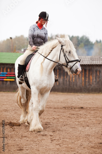 Photo: Young woman riding shire horse Young woman riding shire horse