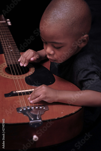 Photo: little boy plays the guitar little boy plays the guitar