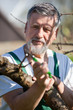 Portrait of a senior man gardening in his garden - taking care o