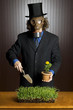 Businessman wearing a gasmask holding a potting shovel