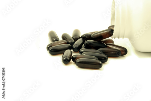 Photo: Vitamin Gel Capsules Spilling Out Of Bottle Vitamin Gel Capsules Spilling Out Of Bottle