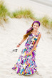 Model girl walking in sand dunes beach
