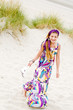Model girl walking in sand dunes beach